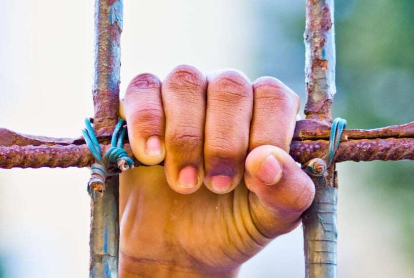 hand holding fence