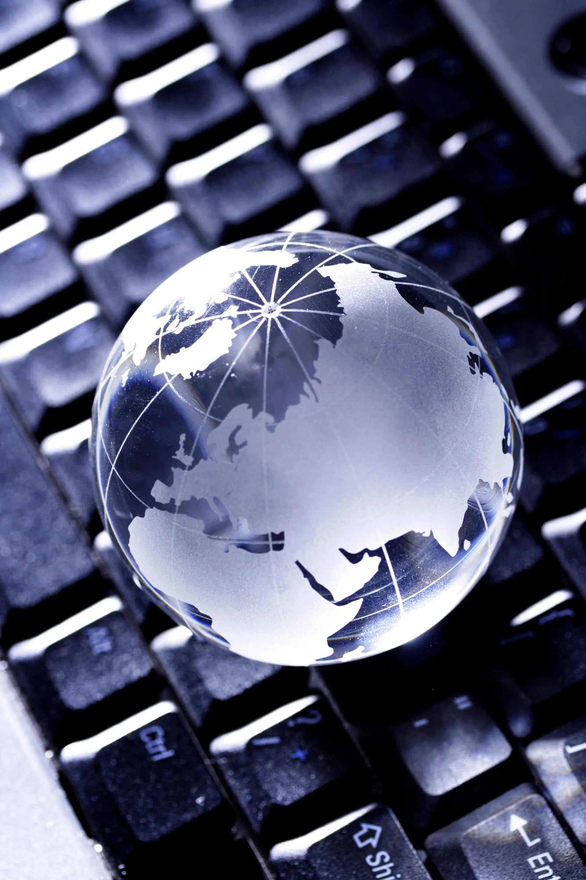 Glass globe on computer keyboard