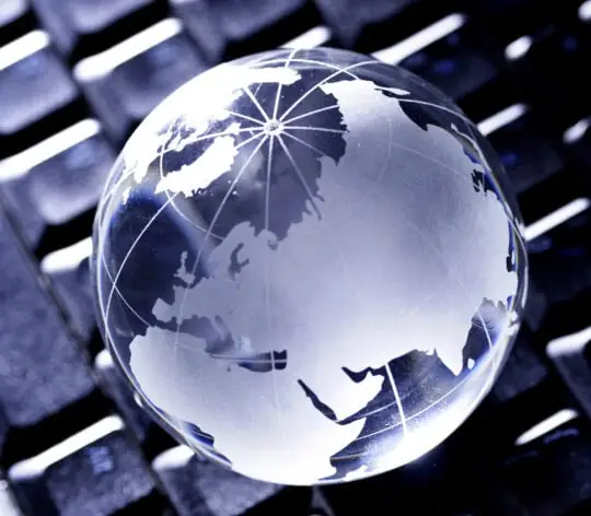 Glass globe on computer keyboard
