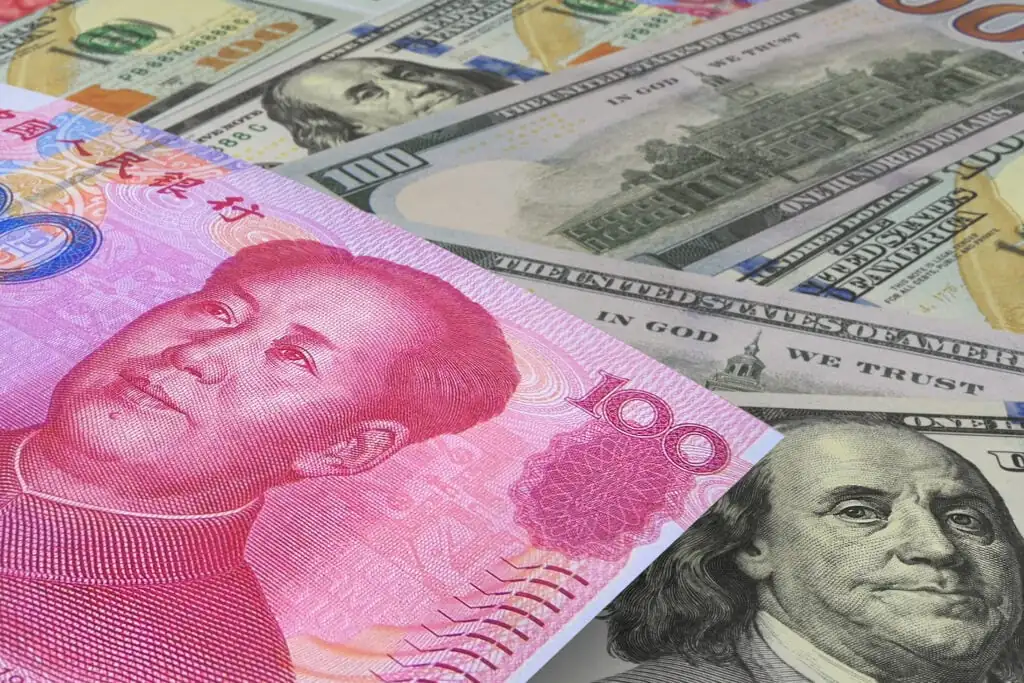 Chinese Yuan banknotes with US dollars in the background. Cash. Financial concept.