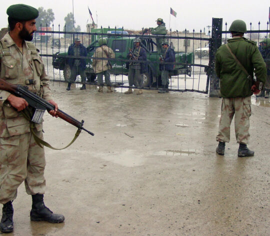 Pakistani paramilitary soldiers stand gu