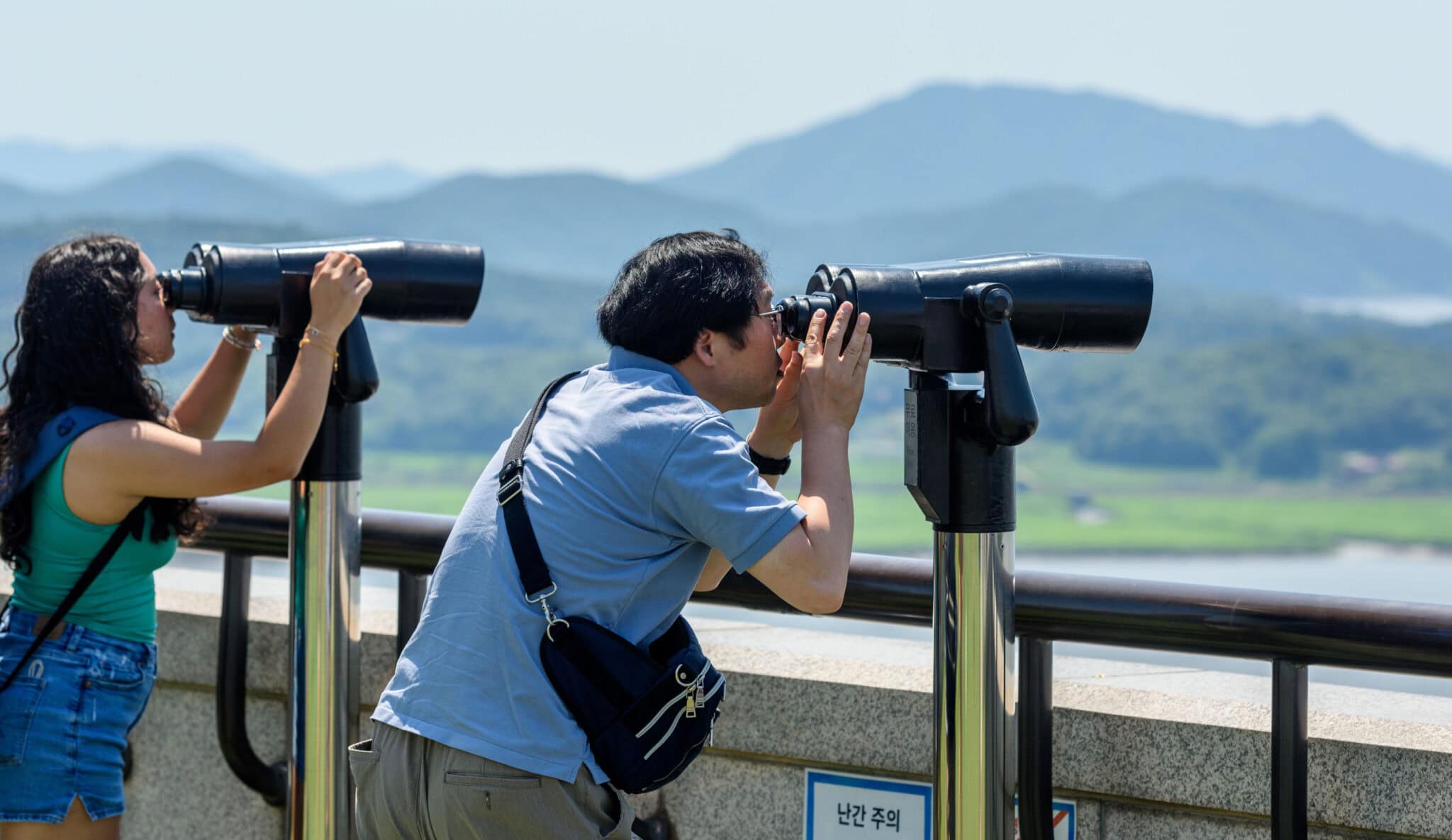 Visitors use binoculars to view the North Korean side from